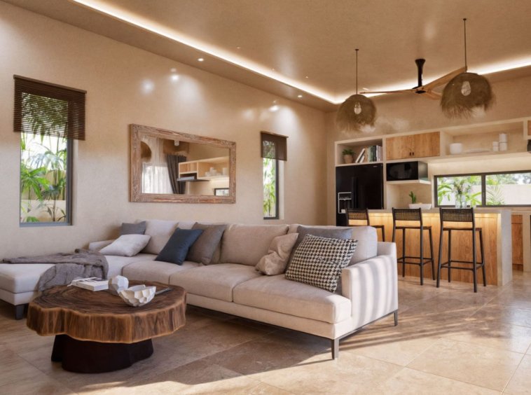Salon cuisine villa Koh Samui – séjour ouvert avec canapé d'angle, table basse en bois brut et cuisine équipée en arrière-plan